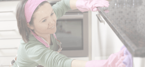 smiling woman cleaning a counter top